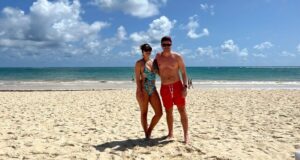 Foto casal em pe na areia da praia